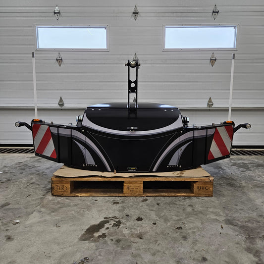 The TractorBumper Toolbox, a spacious black XL sealed toolbox with red-and-white striped panels, is placed on a wooden pallet in a garage with a white sectional door. Two white poles and integrated LED lighting enhance its functionality.